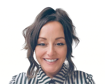 A woman wearing a striped shirt smiles warmly