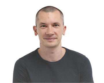 A seated man in a black t-shirt